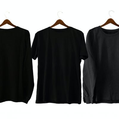 three dark t-shirts on hangers